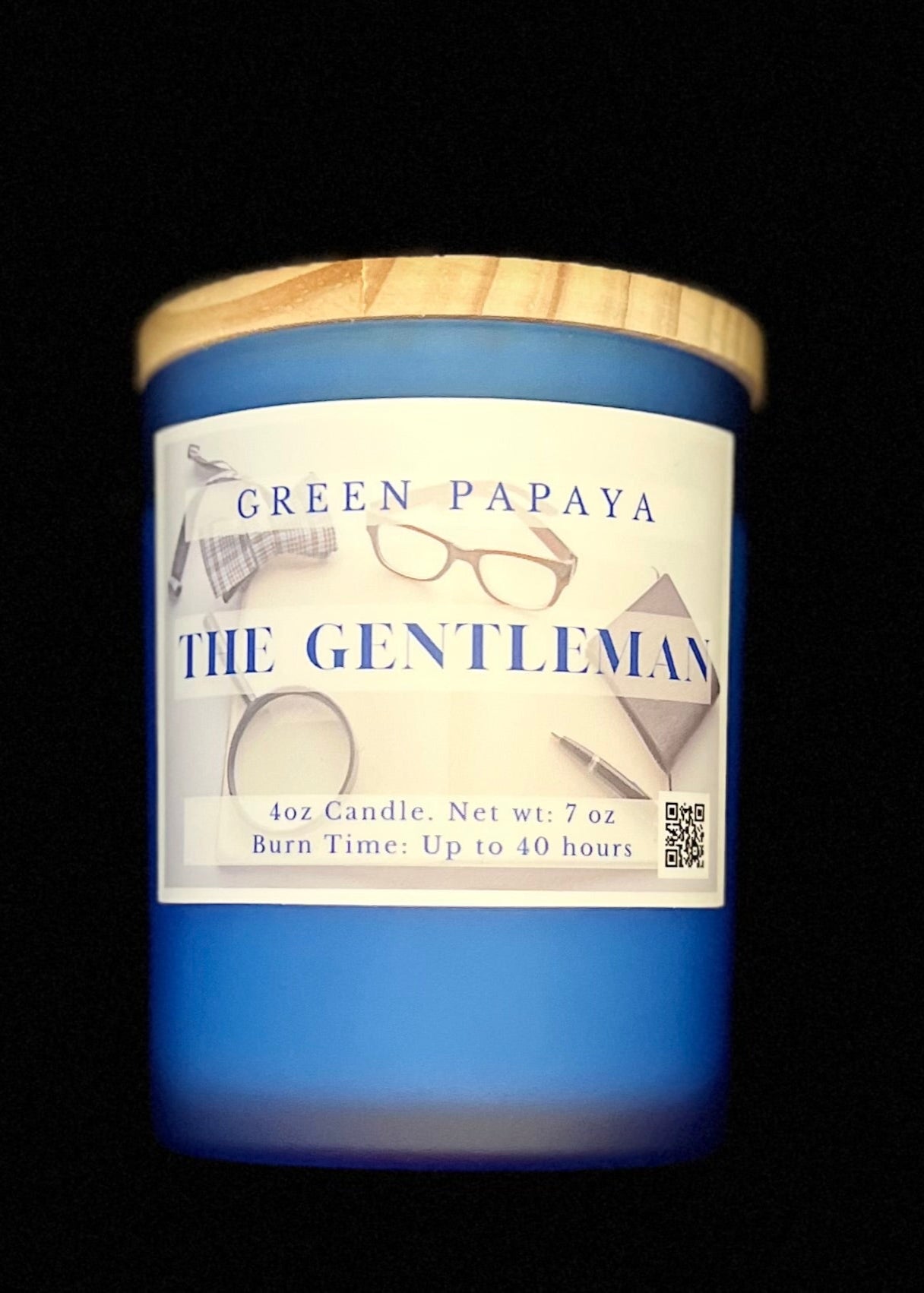 Blue candle with a wooden lid labeled 'Green Papaya The Gentleman' on a black background