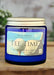 Blue candle jar labeled 'Tee Time' with a visible brand label on a dark background