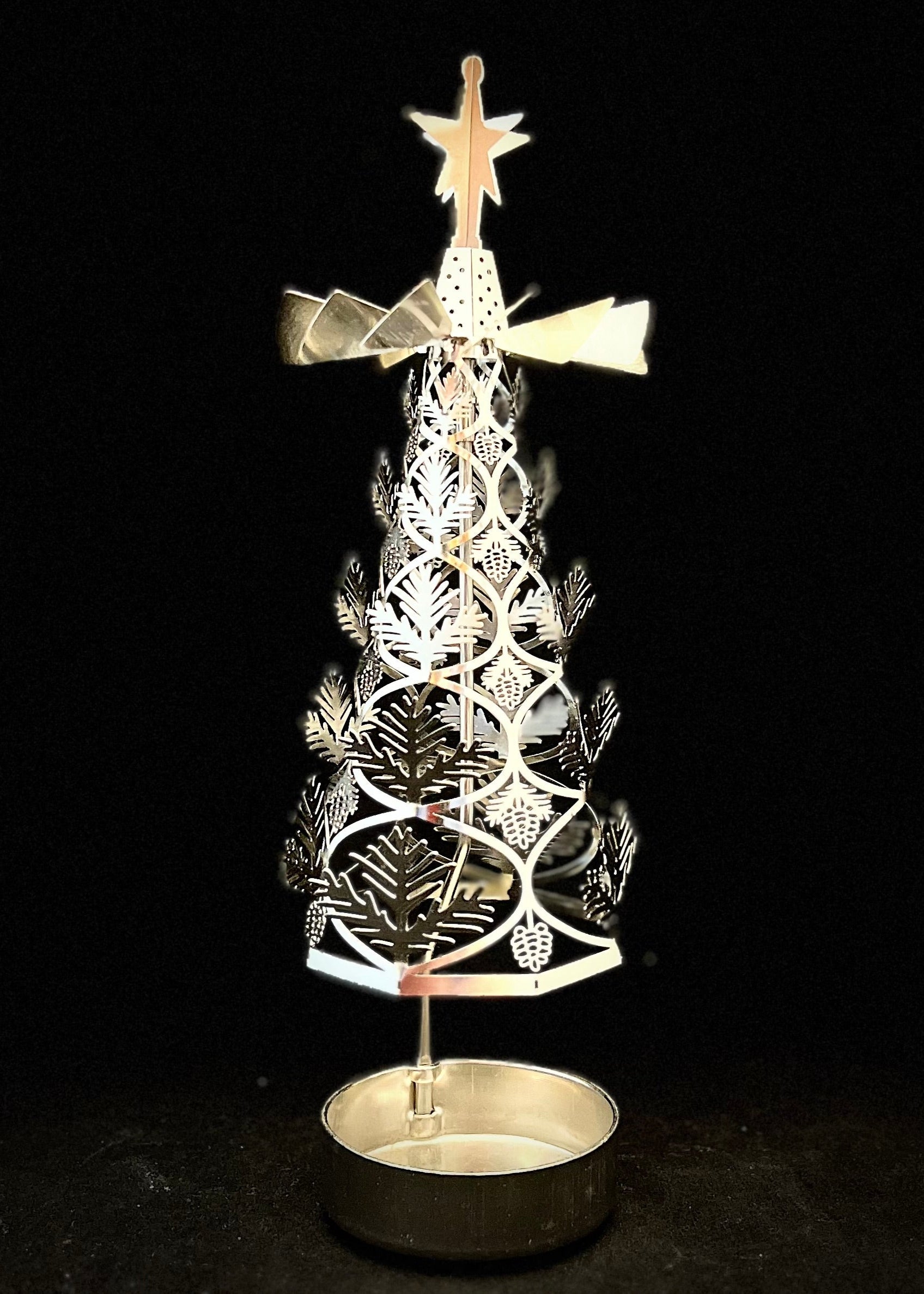 Decorative Christmas tree with star on top against a black background