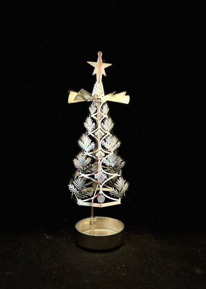 Decorative metal Christmas tree with star on top against a black background