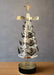 Decorative silver Christmas tree with star on top against a black background
