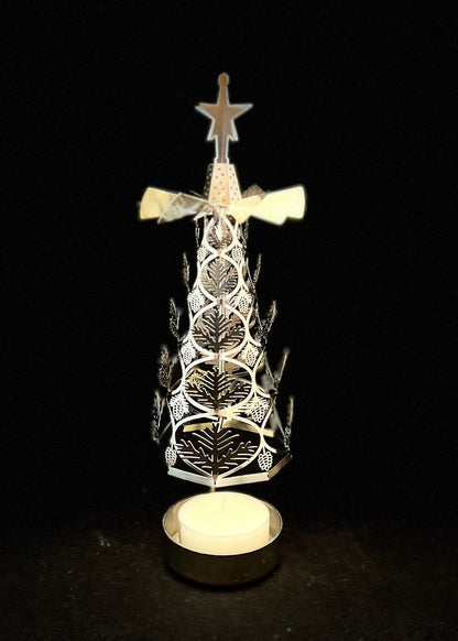 Decorative Christmas tree with star on top, illuminated against a black background