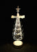 Decorative Christmas tree with star on top, illuminated against a black background