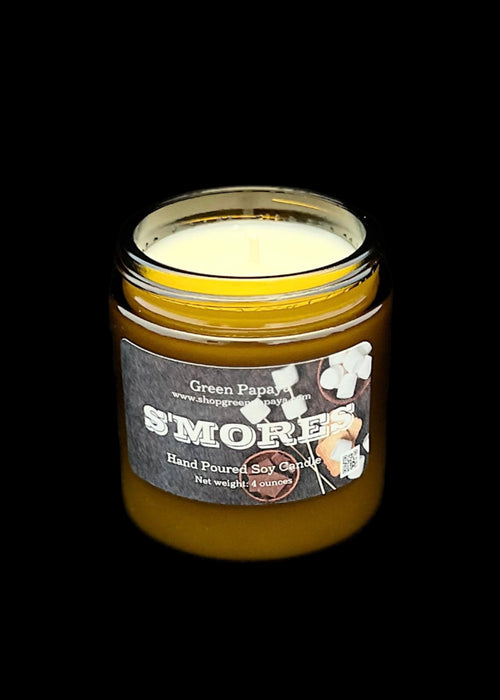 S'mores candle in a glass jar with a label on a dark background
