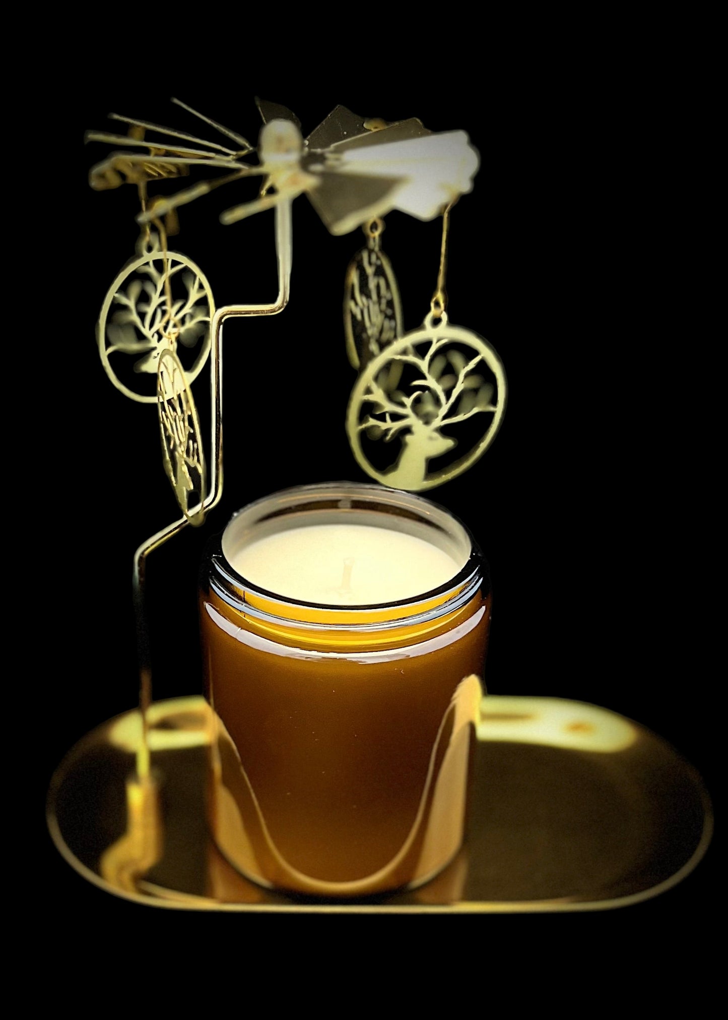 Decorative candle with metal art on a black background