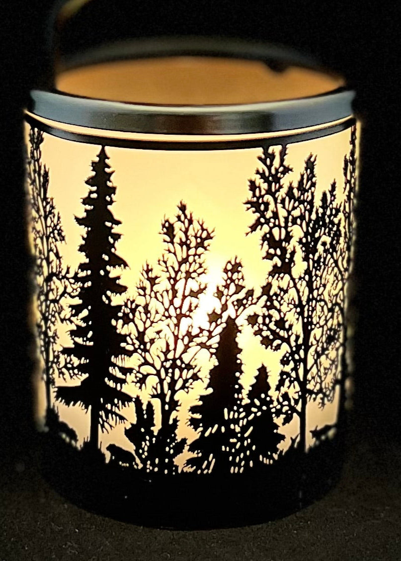 Candle holder with forest design on a black background