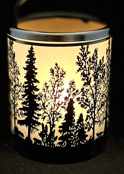 Candle holder with forest design on a black background