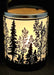 Candle holder with forest design on a black background