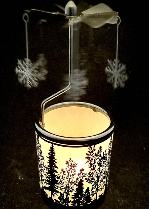 Decorative lantern with winter scene design on a dark background