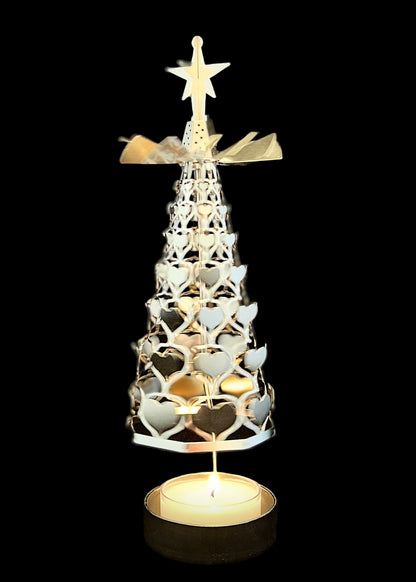 Decorative candle holder shaped like a Christmas tree with a star on top against a black background