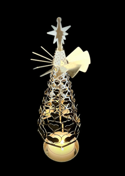 Decorative Christmas tree with a star on top, illuminated against a black background