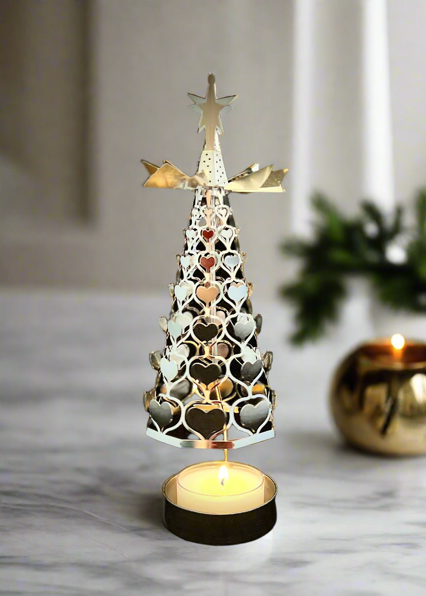 Decorative Christmas tree with heart shapes and a star on top, illuminated against a black background.